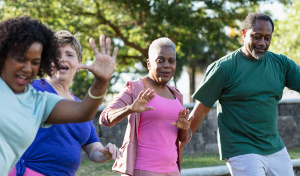 istock Mature and senior adults taking exercise class in park 1494661915
