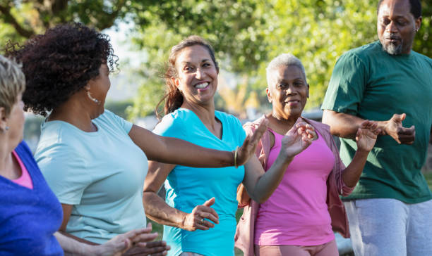 istock Mature and senior adults in dance exercise class in park 1494661933