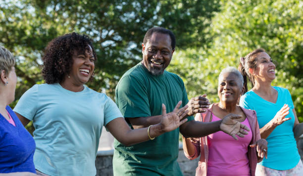 istock Mature and senior adults in dance exercise class in park 1494661939