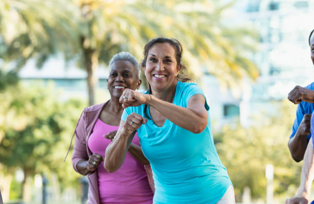 istock Woman having fun in exercise class outdoors 1494661988