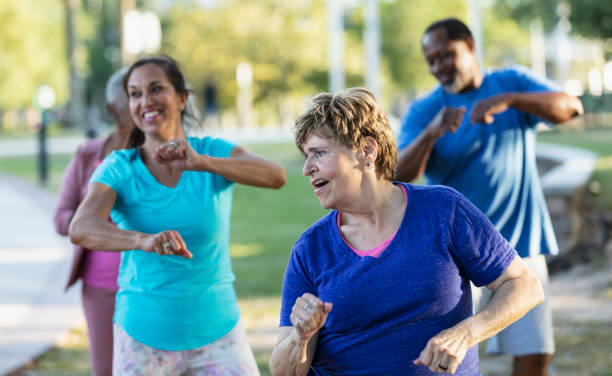 istock Senior woman having fun in exercise class outdoors 1494661994