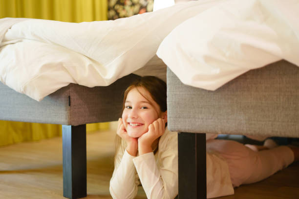 istock Little pretty girl hiding under bed 1494663171