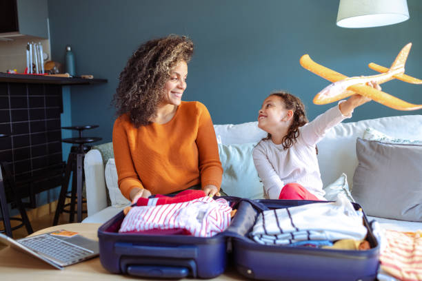 istock Mother and daughter packing for a trip 1494664376