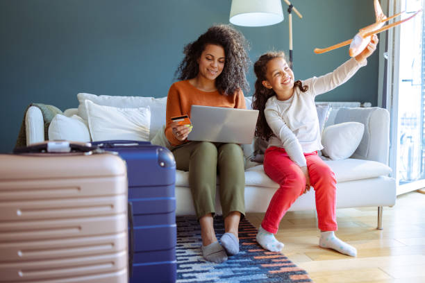 Mother and daughter choosing their next vacation destination stock photo
