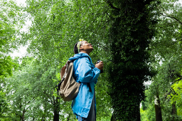 Cheerful young woman spends her vacation in nature by taking walks