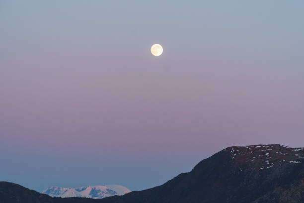 istock Sunset landscape mountains pink sky with clouds and moon 1494666910