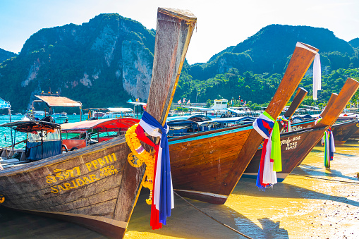 Koh Phi Phi Krabi Thailand 22. October 2018 Longtail boat boats at the beautiful famous beach lagoon between limestone rocks and turquoise water on Koh Phi Phi Don island in Ao Nang Krabi Thailand.
