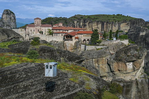 Gondola on a cable winch as access to the Monastery Agia Triada (Holy Trinity) in Meteora which was built high on the top of a rock in the mountain landscape near Kalambaka, Greece, copy space