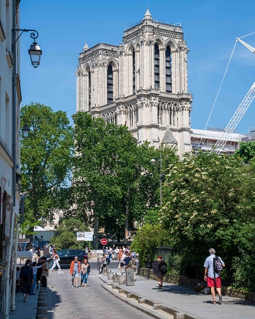 Paris, France - May 29, 2023: Notre Dame de Paris Cathedral seen from Rue Saint-Julien le Pauvre