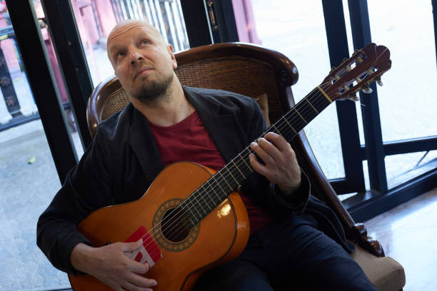 istock Skillful male guitarist performs with emotion in indoor concert 1494676934