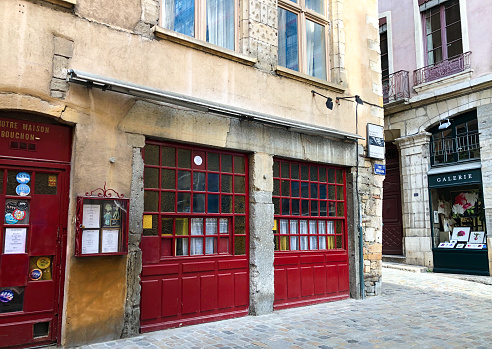 Lyon, France: An old-fashioned restaurant with bright red windows on a corner in Vieux Lyon.