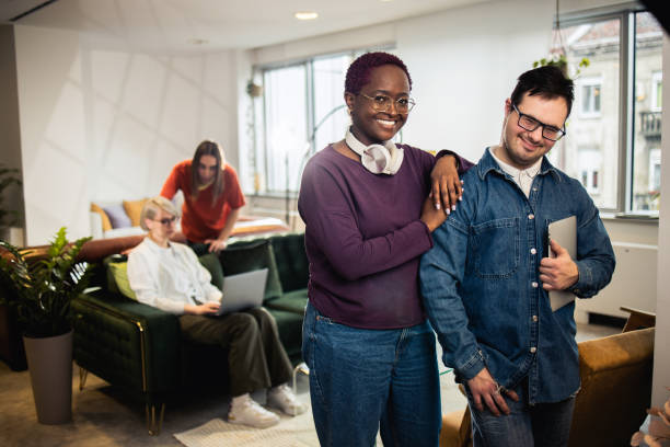 istock Young man with Down syndrome having fun with his colleague 1494677169