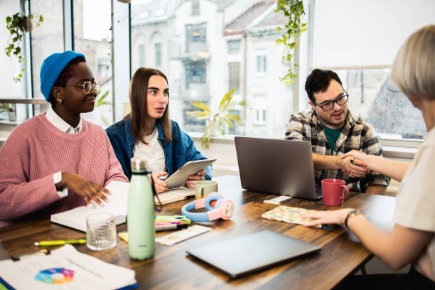 istock Diverse group of young people making a business plan together 1494677188