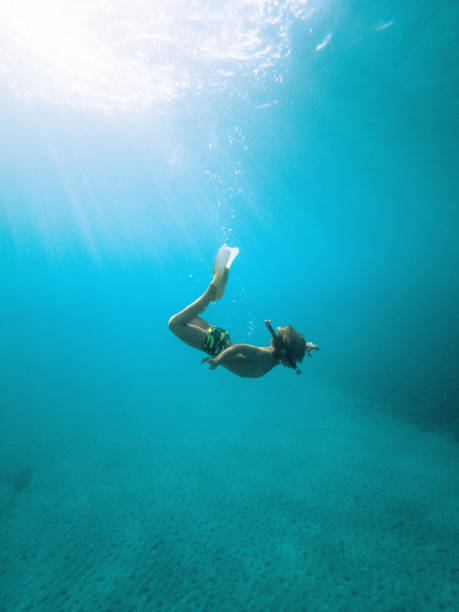 istock Playful Day in the Water, Cute Boy Snorkeling 1494679111
