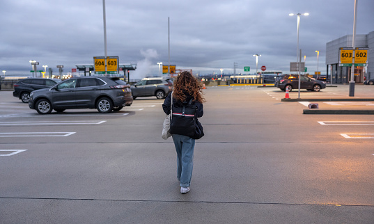 Woman going to the international airport terminal in the evening.