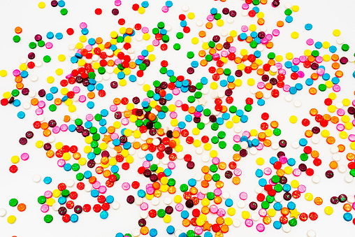 High angle view of sugar sprinkles over white background,Image made in studio.