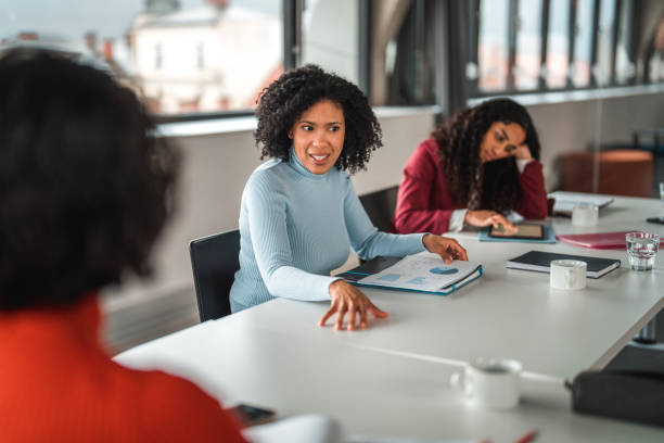 istock Over the Shoulder View of Two Good Looking Women at Work 1494679212