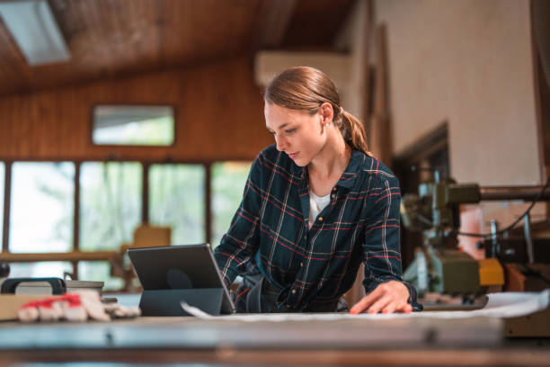 istock Short Hair Caucasian Woman using Digital Tablet at Workshop 1494679788