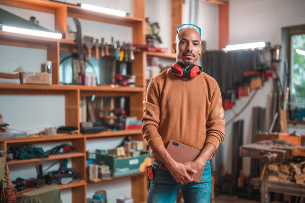 istock Portrait of Bold Male Carpenter Holding Notebook 1494679799