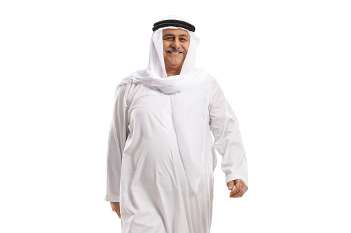 Cheerful mature arab man walking isolated on white background