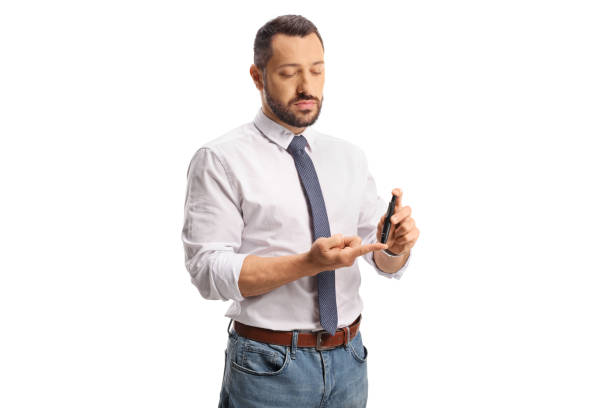 istock Young man pricking finger with a medical device 1494682413