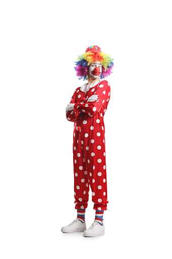 Clown in a red costume posing with folded arms isolated on white background