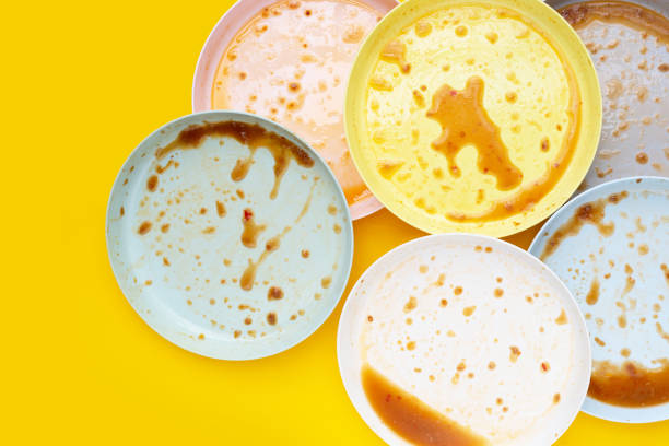 istock Dirty dishes on yellow background. Top view 1494687932