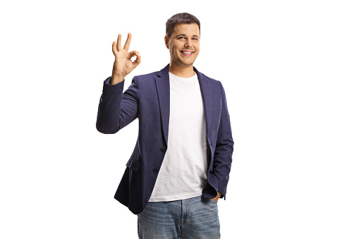 Young man gesturing ok sign isolated on white background