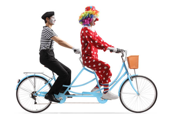 istock Mime and a clown riding a tandem bicycle 1494692543