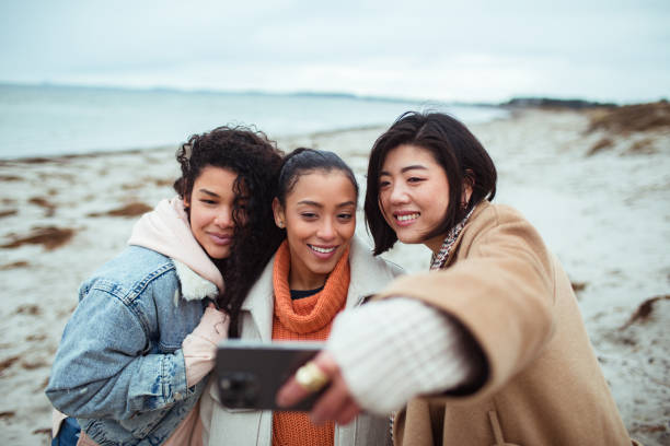 istock Three young women taking a selfie on a beach 1494694675