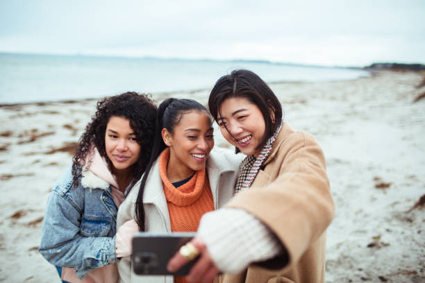 istock Three young women taking a selfie on a beach 1494695166
