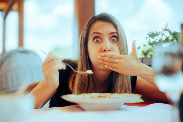 istock Woman Eating Soup in a Restaurant Feeling Sick 1494704239
