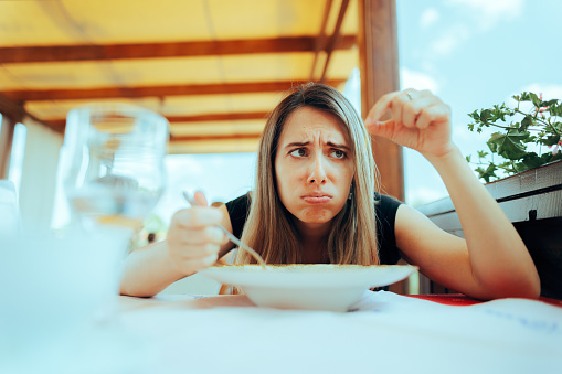 Displeased customer having her meal ruined by cooking failure