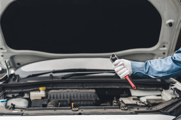 istock Examples of auto care maintenance and servicing include the close-up view of a hand technician auto mechanic using a wrench to remedy a spare component vehicle engine issue. 1494707813