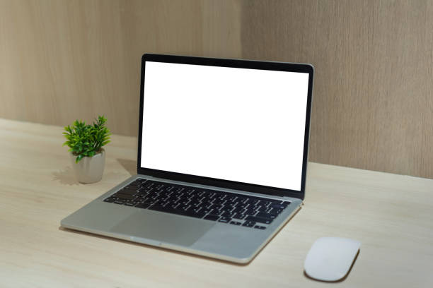 istock Mock up laptop computer blank white screen on desk. 1494707950