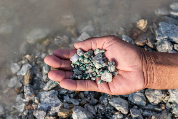 istock Man showing some raw emerald stone found in the river 1494710511