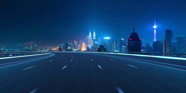 istock Highway overpass motion blur with city 1494711060