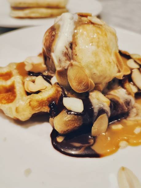 istock Caramel Chocolate waffle with vanilla ice cream and almond slices 1494711110