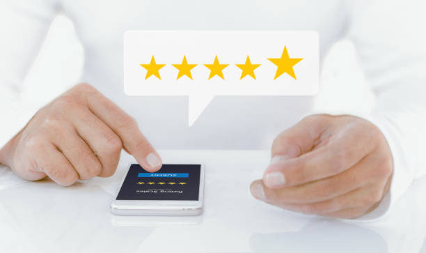 istock Male hand holding a mobile phone Rate your experience with a five-star concept. Providing a 5-star rating or review in a survey,  questionnaire or customer satisfaction research. 1494713075