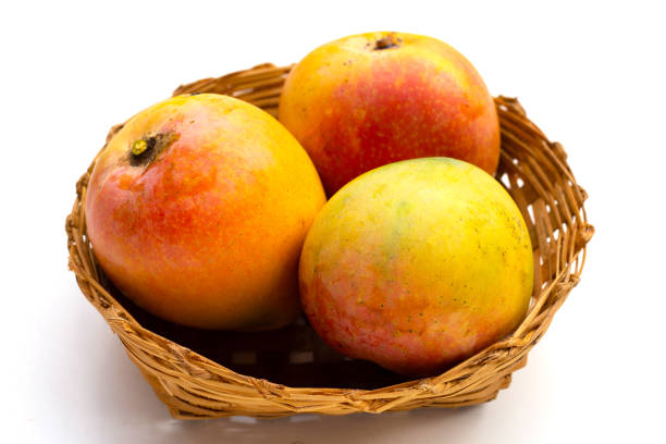 istock Mango in bamboo basket on white background. Tropical fruit 1494715195