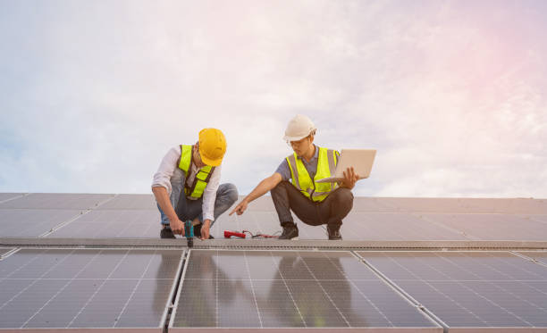 istock Service Engineer use tablet working inspection installation solar cell on the roof. 1494717662