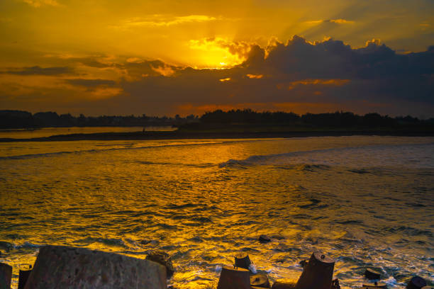 Tetrapods or breakwaters on the Glagah Beach, Kulonprogo, Indonesia during sunrise. stock photo