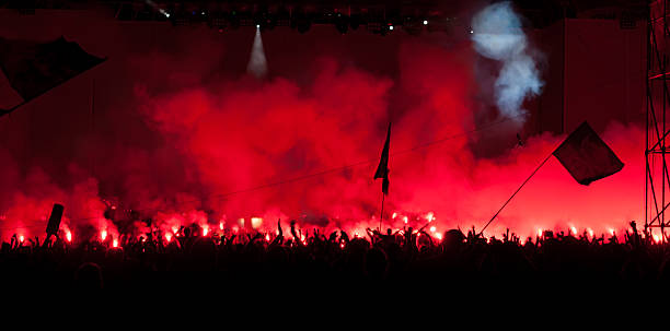 istock Fans burn red flares at rock concert 149472073