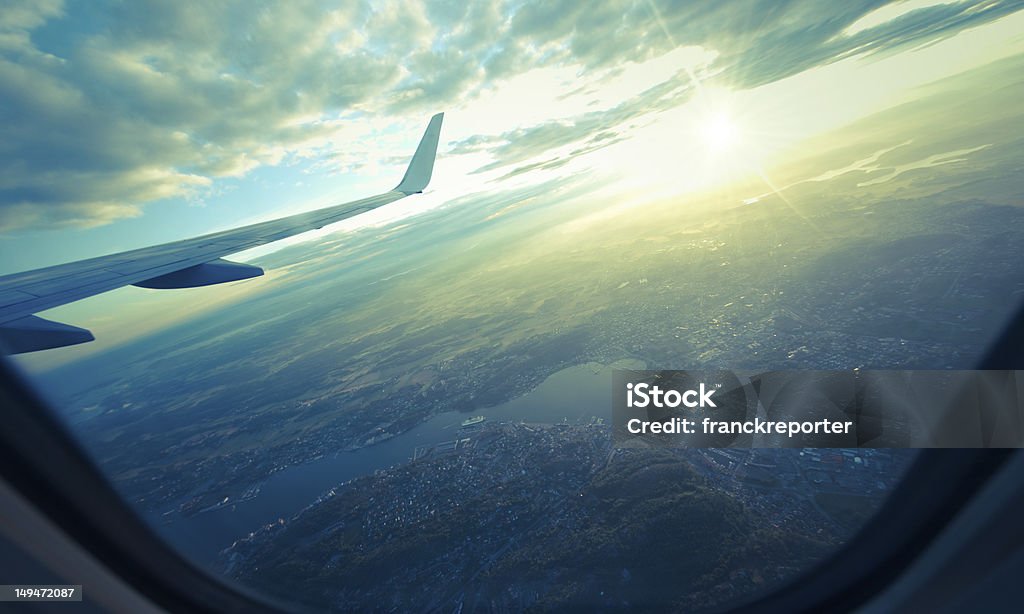 landscape view from airplane porthole on sunset  Aircraft Wing Stock Photo