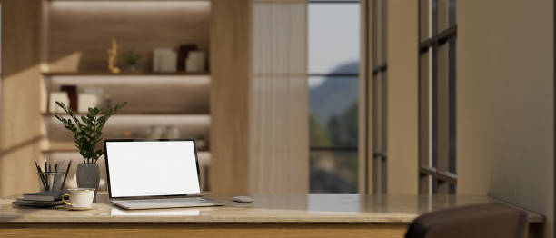 istock Home workspace with laptop mockup on a table in modern luxury working room. 1494721506