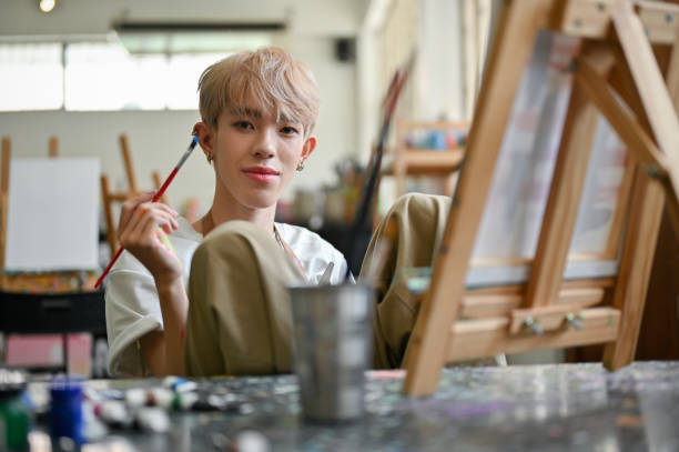istock An attractive Asian gay man or queer joining a creative art workshop in the studio 1494722733