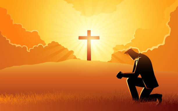 istock Man praying with a cross and a light burst on a hill in the background 1494723291