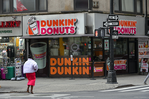 New York City - February 19, 2023: Exterior signs on one of Dunkin Donuts locations at Manhattan, New York City, United States