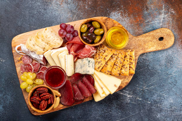 istock Antipasto board with prosciutto, salami, crackers, cheese 1494726249