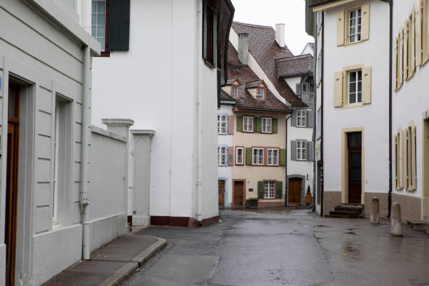 istock Old buildings in an empty street with wet ground 1494732569